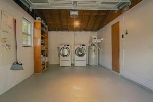 a room with three washing machines in it at 2 homes within 5 miles of each other, one on Lake in Lutz