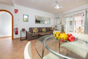 a living room with a glass table with fruit on it at Calas Beach Corralejo in Corralejo