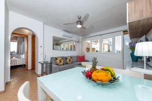 a living room with a table with a bowl of fruit at Calas Beach Corralejo in Corralejo