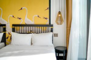 Postel nebo postele na pokoji v ubytování Rokas Hoi An Boutique Hotel