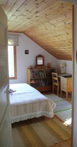 a bedroom with a bed and a table and a desk at Lamminkangas Cottage in Kalmari