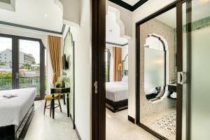 Postel nebo postele na pokoji v ubytování Rokas Hoi An Boutique Hotel