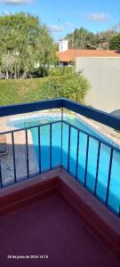 a balcony with a swimming pool on top of a building at VICTORIA 2 bed and breakfast departamento in Ezeiza