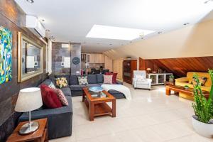 a living room with a couch and a table at Calas Beach Corralejo in Corralejo