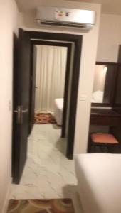 a hallway leading to a room with a door and a room with at Porto golf marina in El Alamein +15 photos