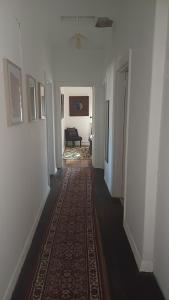 a hallway with a rug on the floor of a house at The Willery Guesthouse in Dimboola