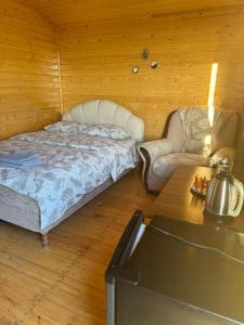 a bedroom with a bed and a chair and a table at Eco Aura (RestZone) in Areguni
