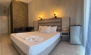 Postel nebo postele na pokoji v ubytování Ellas Hotel