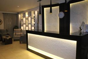 a lobby with a counter with a clock on the wall at Salome Hotel in Madaba