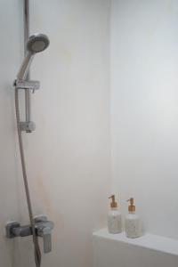 a shower in a bathroom with two bottles on a counter at The Shore Koh Chang Boutique Resort in Ko Chang