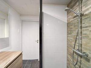 a shower with a glass door in a bathroom at Ideal holiday home with garage in Blankenberge +13 photos