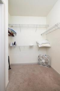 a white room with a fan and shelves at Stunning Nulu 1BR CozySuites 06 in Louisville