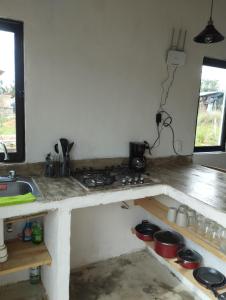 a kitchen with a stove and a counter top at Cabaña paraíso in Los Espinos