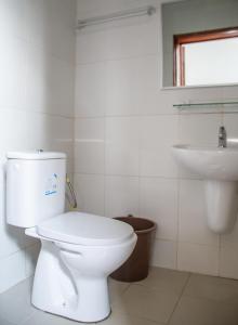 a white bathroom with a toilet and a sink at JRéside Belle Rouge 40m2 centre-ville in Cotonou +22 photos