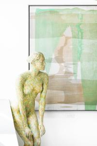 a statue of a woman sitting in front of a window at Augarten Art Hotel in Graz