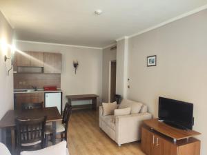 a living room with a couch and a table and a kitchen at Elenite Sea View Apartments in Elenite