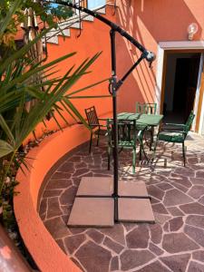a patio with a table and chairs next to a building at Lazar ONE Aparment in Izola