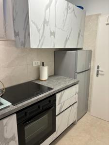 a kitchen with a sink and a refrigerator at Lazar ONE Aparment in Izola