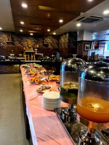 a buffet line with food on a table in a restaurant at Yatri Suites and Spa in Kathmandu