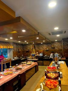 a large kitchen with many plates of food on tables at Yatri Suites and Spa in Kathmandu