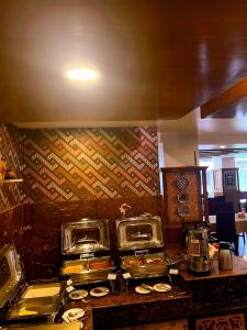 a restaurant kitchen with a counter with food on it at Yatri Suites and Spa in Kathmandu