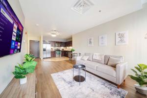 a living room with a couch and a table at Sky High Luxury - 10th Floor - PRIME LOCATION CITY VIEWS FAST WIFI 24-7 Gym Lounge Roku in Pittsburgh +20 photos
