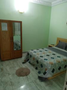 En eller flere senge i et værelse på Hotel Akwaba Abatta