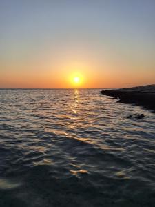 a sunset over a body of water at la vi marsa alam in Marsa Alam City