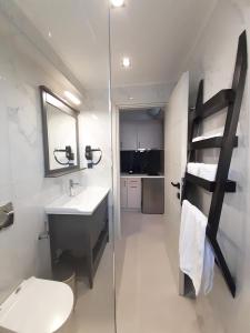 a bathroom with a toilet and a sink and a ladder at Casa Del Sol Luxury House in Xylokastron