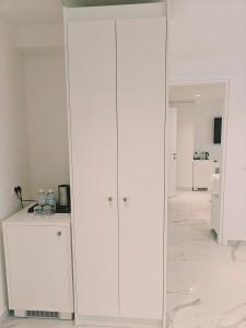a large white cabinet in a white room at Ibiscus Hotel in Rhodes Town