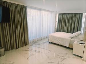 a hotel room with a bed and a marble floor at Ibiscus Hotel in Rhodes Town