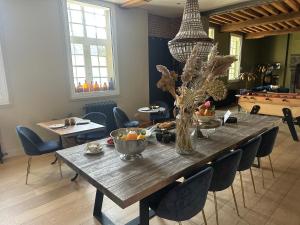 a dining room table with bowls of fruit on it at La Hamaïde in Chéreng