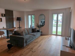 a living room with a couch and a table at Wohnstation Princess Suite in Subingen
