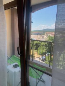 a view of a balcony from a room with a window at Студио Приятели in Tsarevo