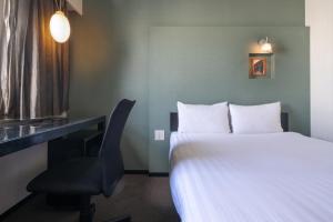 Postel nebo postele na pokoji v ubytování Hotel Vista Atsugi