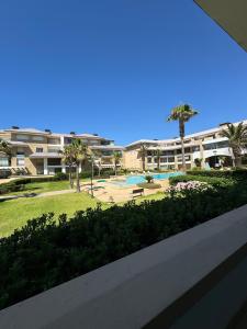 a view of a resort with a pool and palm trees at Prestigia PDN in Sidi Bouqnadel