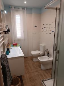 a bathroom with a toilet and a sink at Casa Azzurra in Giardini Naxos