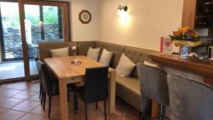 a dining room with a table and a couch at Rheinliebe Bistro und Pension in Lorch am Rhein