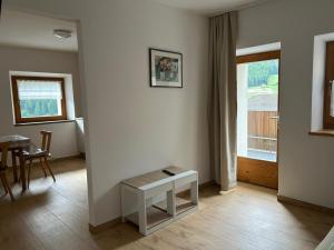 a living room with a table and a window at Ferienhof - agritur Mairulrichhof in Martello