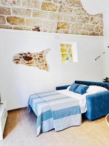 Un dormitorio con una cama y una pared de ladrillo. en Sicilia biedda casa vacanze, en Terrasini