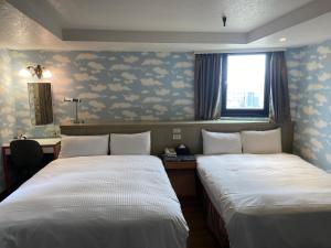 Postel nebo postele na pokoji v ubytování Jin Tsai Shen Hotel