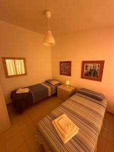 Postel nebo postele na pokoji v ubytování Casa dei gelsomini