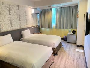 Postel nebo postele na pokoji v ubytování Jin Tsai Shen Hotel