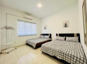a bedroom with two beds and a window at MoonLight Sweet Home Kuala Selangor 30pax karaoke in Kuala Selangor
