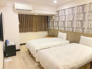 Postel nebo postele na pokoji v ubytování Jin Tsai Shen Hotel