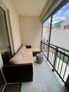 a living room with a couch and a balcony at Studio Prima-Modern Cozy Studio, 4 min to Beach in Pržno +2 photos