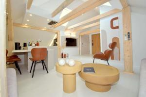a living room with a table and chairs at Apartamenty Blanca in Łeba