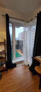 a room with a window with a view of a city at Green Balcony Lille Hyper centre in Lille