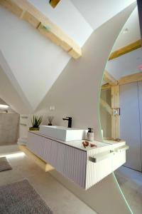 a bathroom with a white tub and a sink at Apartamenty Blanca in Łeba