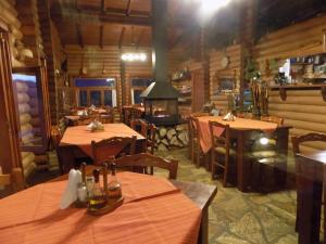 a restaurant with tables and a fireplace in a room at Alagonia Country Homes in Alagonía +69 photos